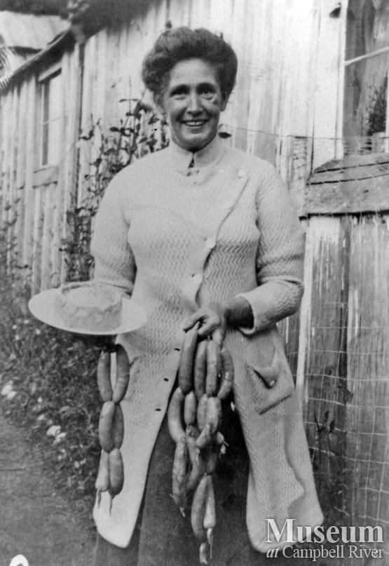 Mrs. James A. Nixon of Twin Islands with string of sausages