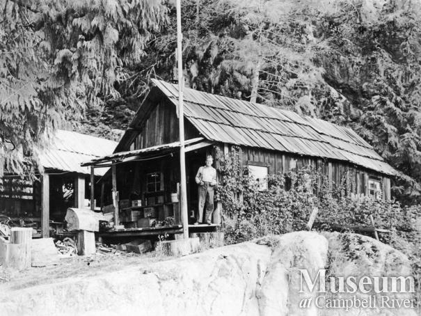 Stapleton on the front steps of his cabin, Toba Inlet