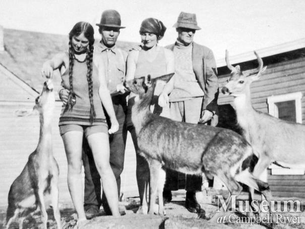 Group with Tom Brazil's pet deer at Blind Bay, Hardy Island