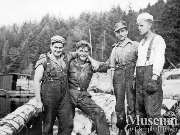 Four loggers at Powell River Company boom at Teakerne Arm