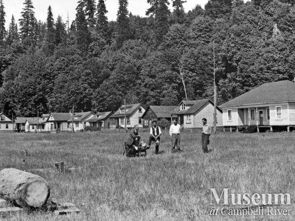 Group in front of the houses at Cape Mudge Village, Quadra Island