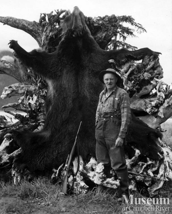 Guide Jim Stanton, with grizzly bear hide in the Knight Inlet area
